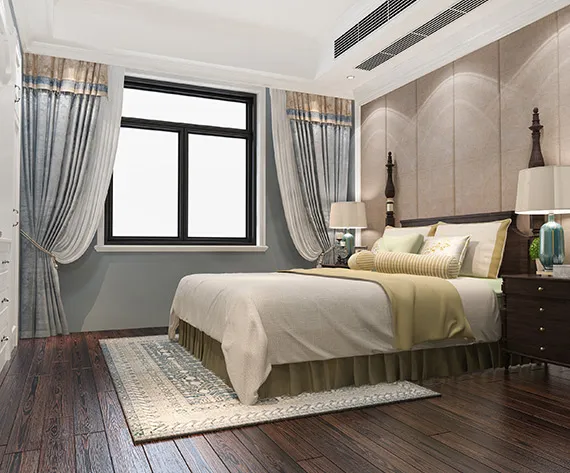 A cozy bedroom with a comfortable bed, a stylish dresser, and a window offering natural light.